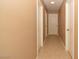 Hallway with tile floor and multiple white doors at 7624 Desert Delta Dr, Las Vegas, NV 89128