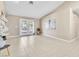 Spacious living room featuring tile flooring, neutral walls, and French doors to a patio at 7624 Desert Delta Dr, Las Vegas, NV 89128