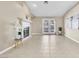 Bright living room featuring a fireplace, tile flooring, and French doors to outdoor space at 7624 Desert Delta Dr, Las Vegas, NV 89128