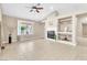 Bright living room featuring a fireplace with built-in shelves, and large windows, creating a welcoming ambiance at 7624 Desert Delta Dr, Las Vegas, NV 89128