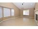 Bright living room with large windows and fireplace at 7624 Desert Delta Dr, Las Vegas, NV 89128