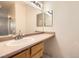 Bathroom featuring a single sink vanity and large mirrors at 7728 White Flower Ct, Las Vegas, NV 89131