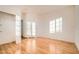 Bright bedroom with hardwood floors, a closet, and sunny windows at 7728 White Flower Ct, Las Vegas, NV 89131