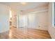 A brightly lit bedroom featuring hardwood floors and a closet at 7728 White Flower Ct, Las Vegas, NV 89131