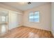 Sunlit bedroom featuring hardwood floors, a closet, and a large window at 7728 White Flower Ct, Las Vegas, NV 89131