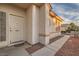 Inviting front entrance with a white door, textured exterior, and pathway to the side yard at 7728 White Flower Ct, Las Vegas, NV 89131