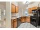 Spacious kitchen featuring wood cabinets, stainless appliances, and tiled flooring at 7728 White Flower Ct, Las Vegas, NV 89131