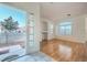 Bright, airy living room with laminate floors and a large window providing ample natural light at 7728 White Flower Ct, Las Vegas, NV 89131