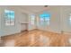 Well-lit living room with beautiful laminate floors, arched windows and a charming built-in alcove at 7728 White Flower Ct, Las Vegas, NV 89131