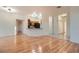 Open concept living and dining area with laminate flooring and a breakfast bar overlooking the kitchen at 7728 White Flower Ct, Las Vegas, NV 89131