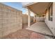 Covered patio area with a concrete floor and block wall, offering a private outdoor space at 7728 White Flower Ct, Las Vegas, NV 89131