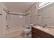 Comfortable bathroom featuring tiled walls, a tub-shower combo, and an updated vanity with a modern faucet at 7885 W Flamingo Rd # 1016, Las Vegas, NV 89147