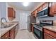 A well-lit kitchen with stainless steel appliances, granite countertops, and wooden cabinetry at 7885 W Flamingo Rd # 1016, Las Vegas, NV 89147