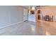 Open-concept living area shows tile flooring, adjacent dining area and kitchen with dark wood cabinets at 7885 W Flamingo Rd # 1016, Las Vegas, NV 89147