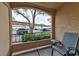 An outdoor patio with a chair offers a relaxed view of the carport, landscaping, and parking area at 7885 W Flamingo Rd # 1016, Las Vegas, NV 89147