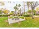 A grassy picnic area with a stone table, surrounded by manicured landscaping and mature trees at 7885 W Flamingo Rd # 1016, Las Vegas, NV 89147