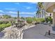 Spacious backyard features a stone patio, manicured landscaping and views of the golf course at 8460 Carmel Ridge Ct, Las Vegas, NV 89113