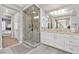 Ensuite bathroom featuring a walk-in shower, dual sinks, and ample counter space at 8460 Carmel Ridge Ct, Las Vegas, NV 89113