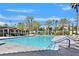 Large community pool featuring shaded lounging areas surrounded by mature palm trees at 8460 Carmel Ridge Ct, Las Vegas, NV 89113