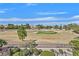 Scenic golf course view showcasing lush greenery, mature trees, and an expansive blue sky at 8460 Carmel Ridge Ct, Las Vegas, NV 89113