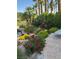 Beautiful landscaping featuring colorful flowers, lush greenery, and elegant stone pathways around the property at 8460 Carmel Ridge Ct, Las Vegas, NV 89113