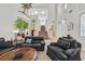 Bright living room featuring a staircase, multiple seating areas, and high ceilings at 8460 Carmel Ridge Ct, Las Vegas, NV 89113