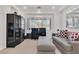 Cozy living room featuring a piano, comfortable seating, and natural light at 8460 Carmel Ridge Ct, Las Vegas, NV 89113