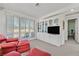 Comfortable living room with built-in display case, a red leather sofa and bright sunlight at 8460 Carmel Ridge Ct, Las Vegas, NV 89113