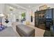 Bright living room with high ceilings, modern furniture, and bar with built in cabinetry at 8460 Carmel Ridge Ct, Las Vegas, NV 89113