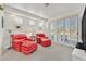 Comfortable living room with red leather sofa and chairs plus a view of the yard at 8460 Carmel Ridge Ct, Las Vegas, NV 89113