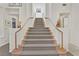 Carpeted stairs with wood railing, leading to the upper level at 8460 Carmel Ridge Ct, Las Vegas, NV 89113