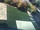 Green artificial grass with stone block patio surrounded by low shrubs at 8494 Langhorne Creek St, Las Vegas, NV 89139