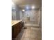 Modern tiled bathroom featuring a frameless glass shower with built in bench and dual shower heads at 8494 Langhorne Creek St, Las Vegas, NV 89139