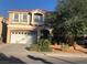 Charming two-story home with a well-manicured lawn, large tree, and a spacious two-car garage at 8494 Langhorne Creek St, Las Vegas, NV 89139