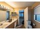 Bathroom featuring double sinks, a toilet, and ample natural light at 8869 Dove Cove Dr, Las Vegas, NV 89129