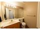 Functional bathroom featuring a toilet, sink, and mirror at 8869 Dove Cove Dr, Las Vegas, NV 89129