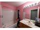 Bright pink bathroom with a shower-tub combo and well-lit vanity at 8869 Dove Cove Dr, Las Vegas, NV 89129