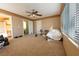 Cozy bedroom featuring carpet floors, ceiling fan, and ample natural light at 8869 Dove Cove Dr, Las Vegas, NV 89129