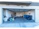 View of a well-lit two-car garage featuring storage cabinets, a water heater, and a black leather couch at 8869 Dove Cove Dr, Las Vegas, NV 89129