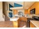 Spacious kitchen features light wood cabinets, an island, and modern appliances for seamless cooking at 8869 Dove Cove Dr, Las Vegas, NV 89129