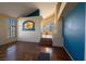 Sun-drenched living room with hardwood floors seamlessly connecting to the kitchen and the upper level at 8869 Dove Cove Dr, Las Vegas, NV 89129