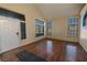 Bright, open-plan living room with gleaming hardwood floors and large windows flooding the space with natural light at 8869 Dove Cove Dr, Las Vegas, NV 89129