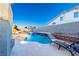 Inviting pool with rock waterfalls, tanning ledge, with patio furniture for relaxing outdoors at 8869 Dove Cove Dr, Las Vegas, NV 89129