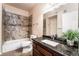 Bathroom with granite vanity, tiled tub, and decorative accents at 9000 Las Vegas Blvd # 1029, Las Vegas, NV 89123