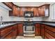 Well-equipped kitchen featuring dark wood cabinets, stainless steel appliances, and granite countertops at 9000 Las Vegas Blvd # 1029, Las Vegas, NV 89123