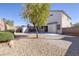 Gravel backyard features a mature tree, storage shed, covered patio, and perimeter block wall at 9678 Swaying Elms Ct, Las Vegas, NV 89147