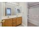 Well-lit bathroom featuring a double sink vanity and a shower-tub combo for convenience at 9678 Swaying Elms Ct, Las Vegas, NV 89147