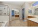 Bright and airy bathroom with tile flooring, dual sinks, and a separate tub and shower at 9678 Swaying Elms Ct, Las Vegas, NV 89147