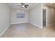 Spacious bedroom with neutral walls, tile flooring, and a ceiling fan at 9678 Swaying Elms Ct, Las Vegas, NV 89147