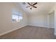 Vaulted bedroom features plush carpet, a ceiling fan, and a sliding-door closet at 9678 Swaying Elms Ct, Las Vegas, NV 89147